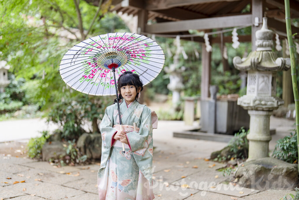 七五三のお祝いで七歳の女の子が美しい和傘を持つ写真